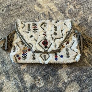 White clutch with embellishments. NWT. Never worn.